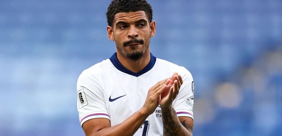 Player applauding while wearing national team jersey