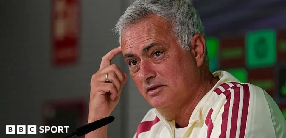 Manager speaking at press conference with microphone