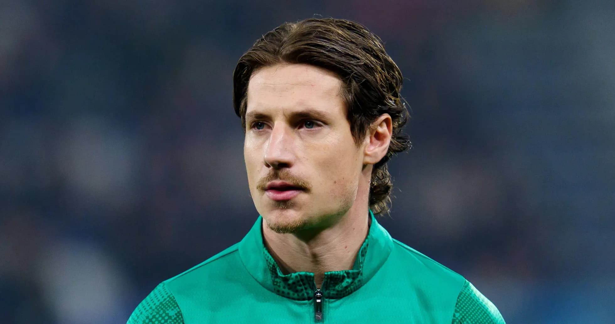 Goalkeeper in green kit during warm-up