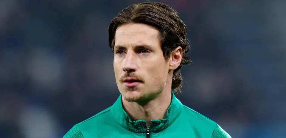 Goalkeeper in green kit during warm-up