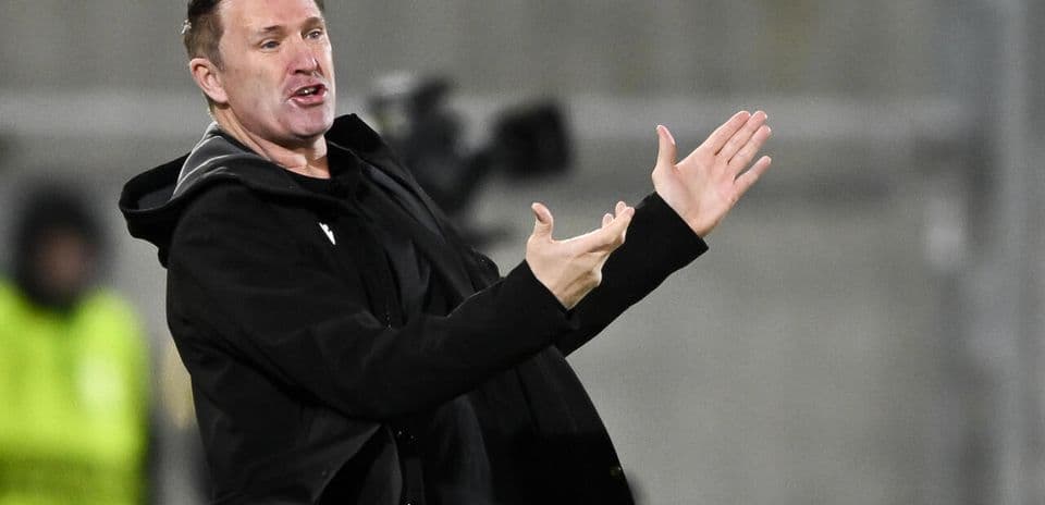 Coach gesturing during a match from the sideline
