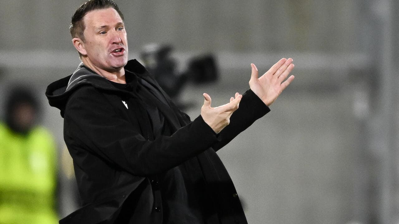 Coach gesturing during a match from the sideline