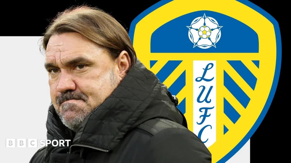 Manager standing in front of Leeds United logo