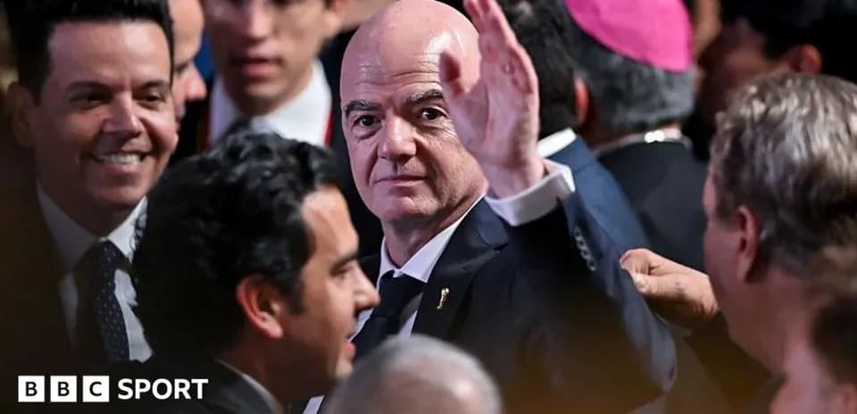 Gianni Infantino waving in a crowded event