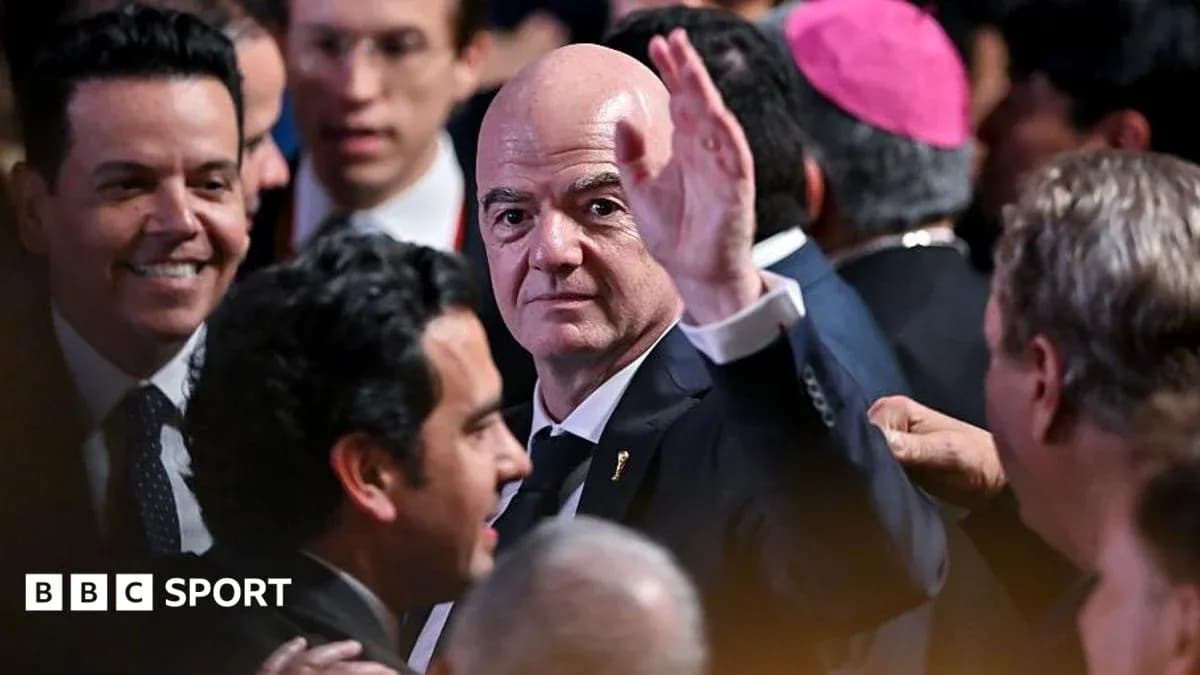 Gianni Infantino waving in a crowded event