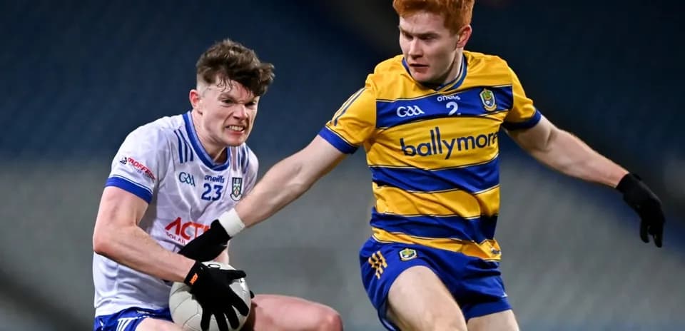 Two players contesting possession of a Gaelic football