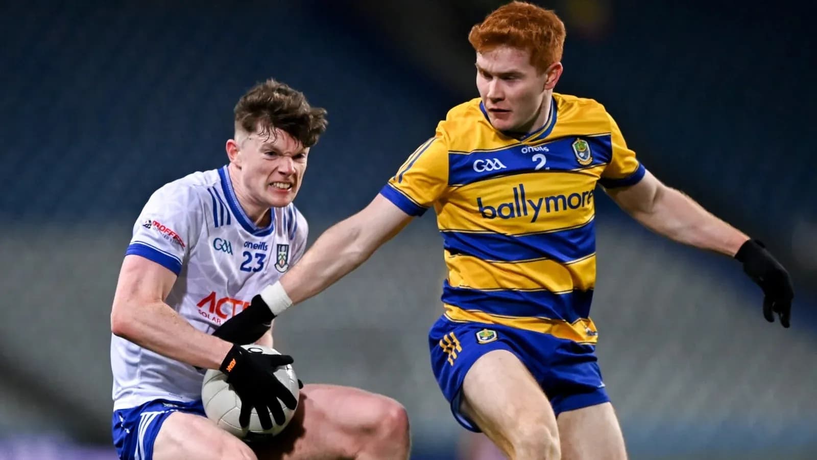 Two players contesting possession of a Gaelic football