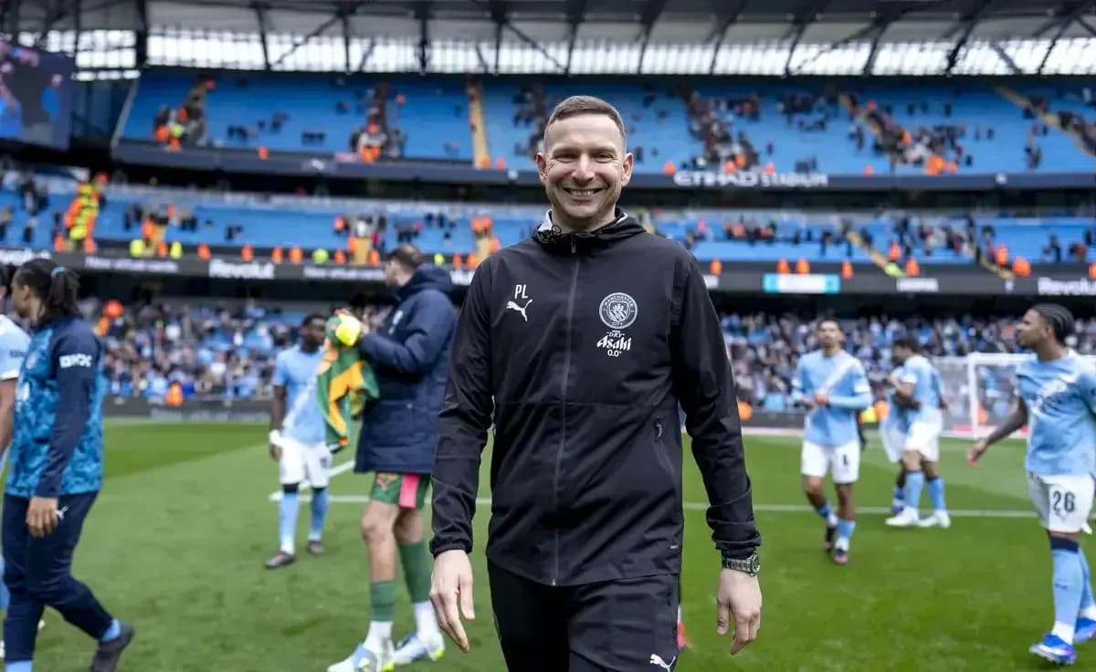 Assistant coach walking off the pitch after match