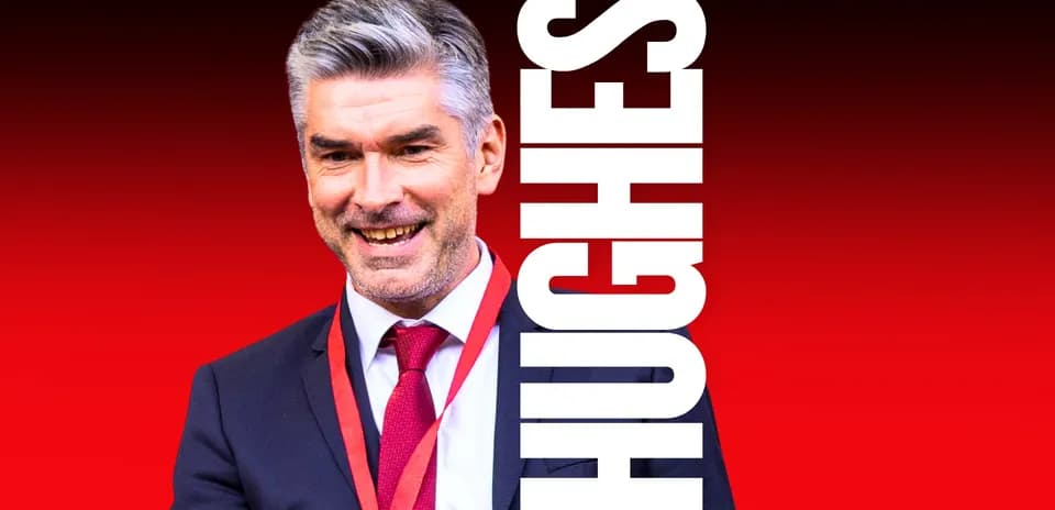 Man in suit smiling with red background