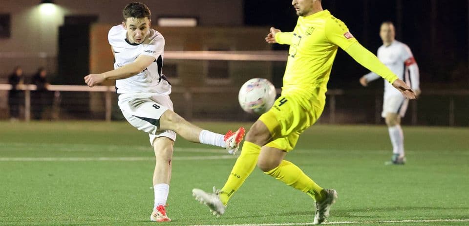 Player kicking ball during SC St. Tönis match