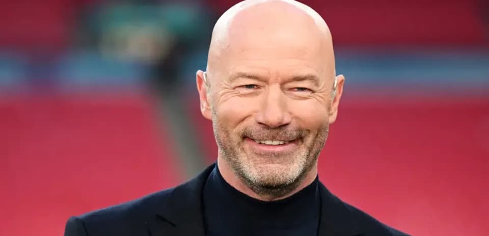 Bald man smiling in a formal outfit