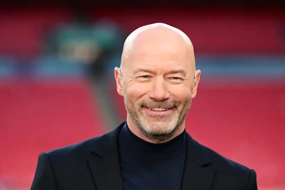 Bald man smiling in a formal outfit
