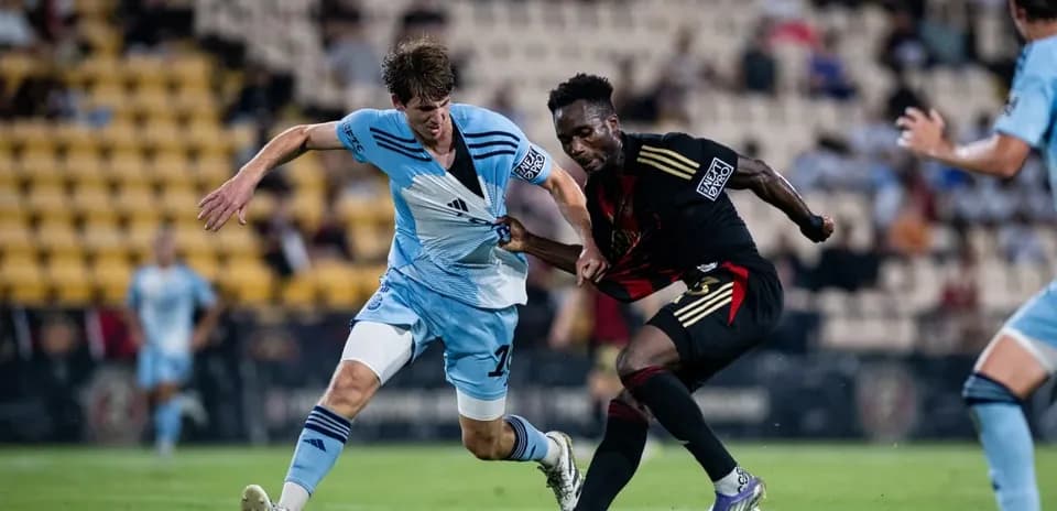 Players competing for the ball in football match