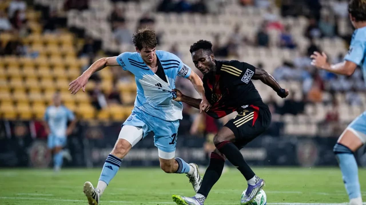 Players competing for the ball in football match