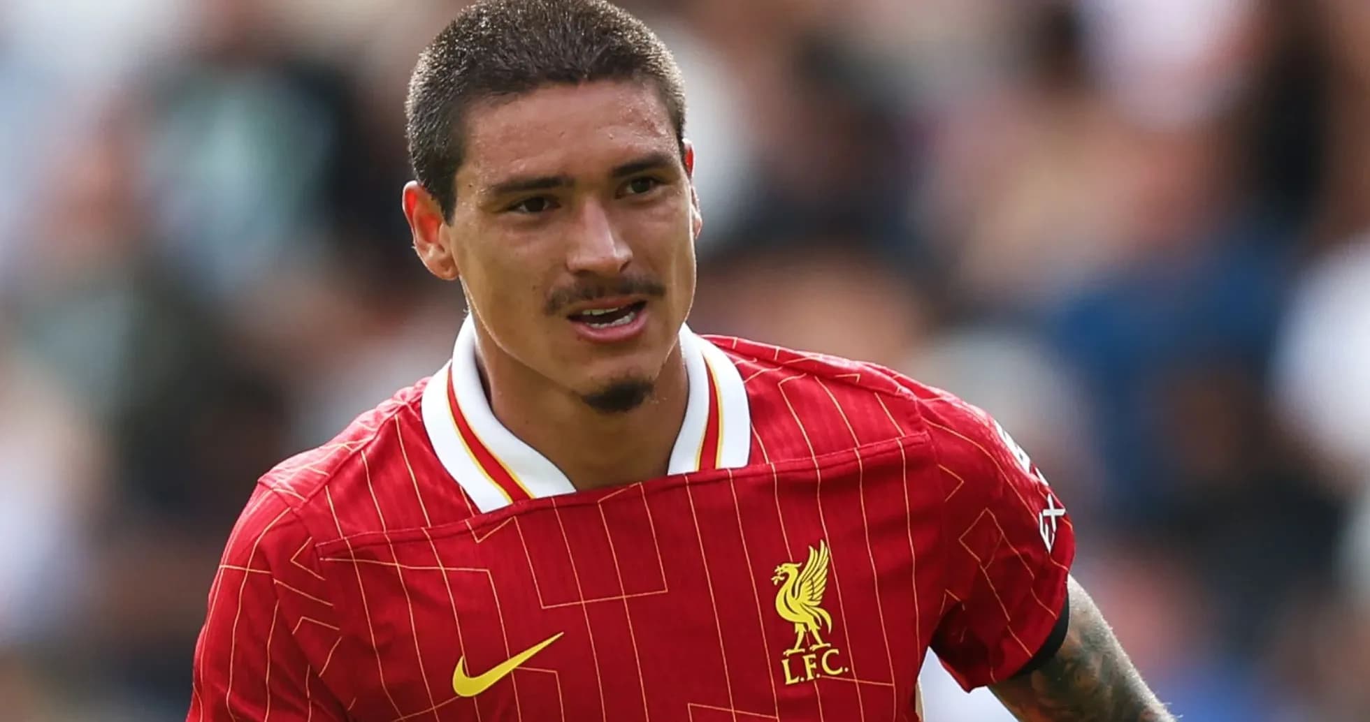 Player in red Liverpool kit running on field