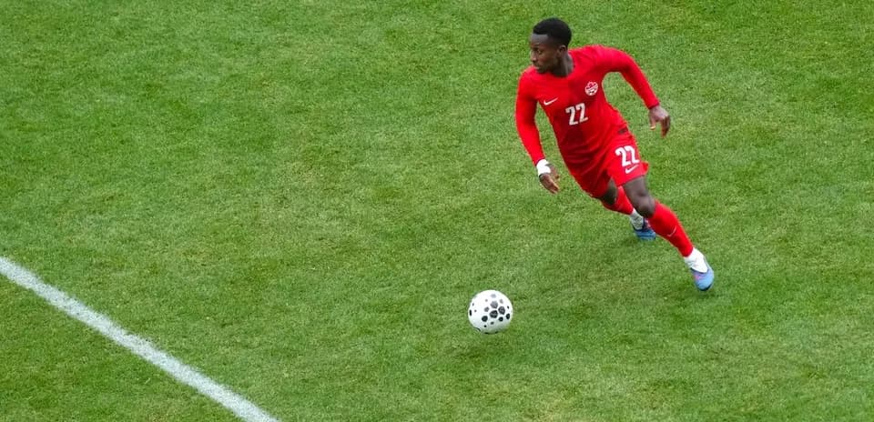 Player in red jersey chasing the ball