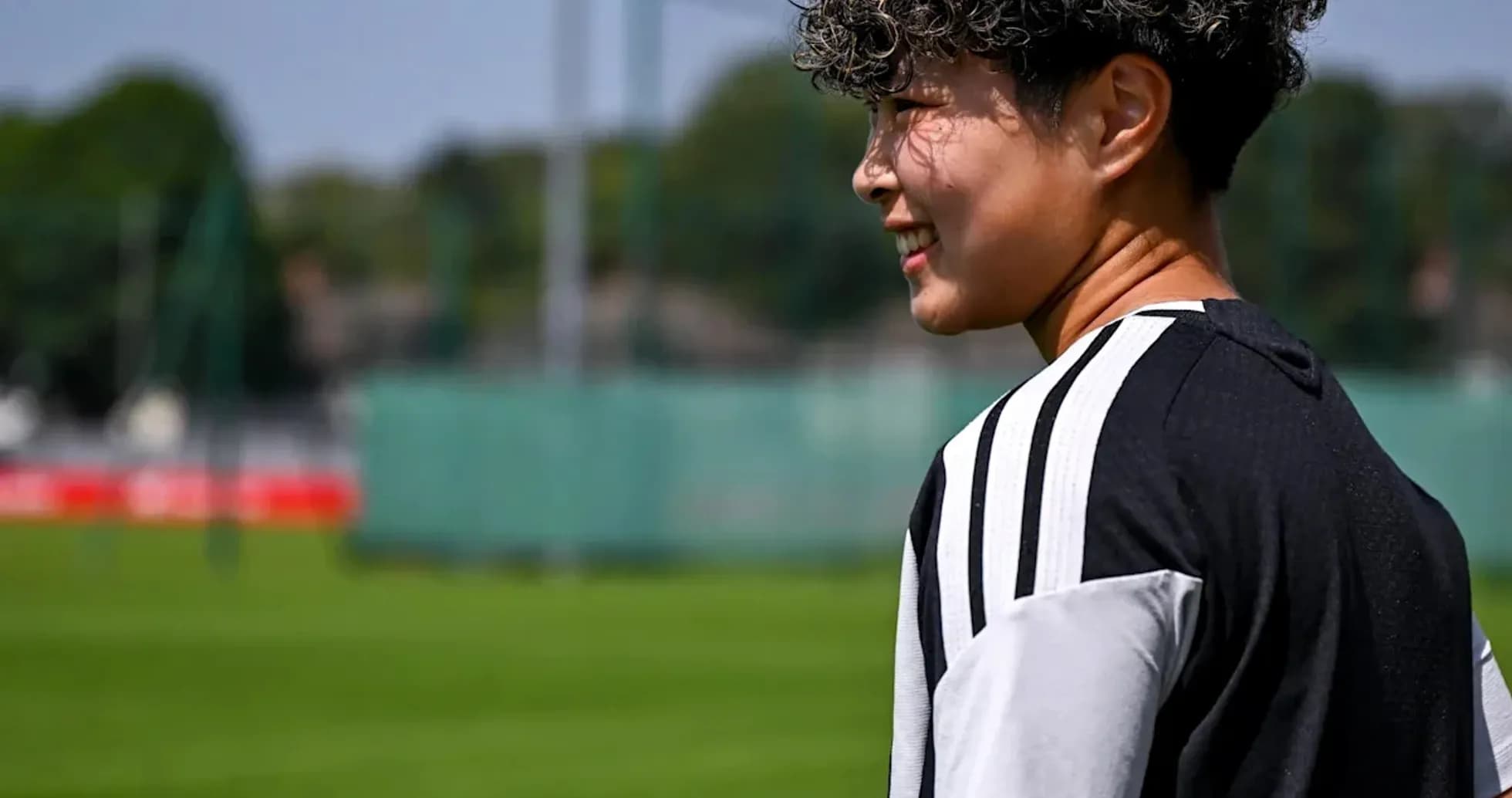 Player walking on training pitch in sunny weather