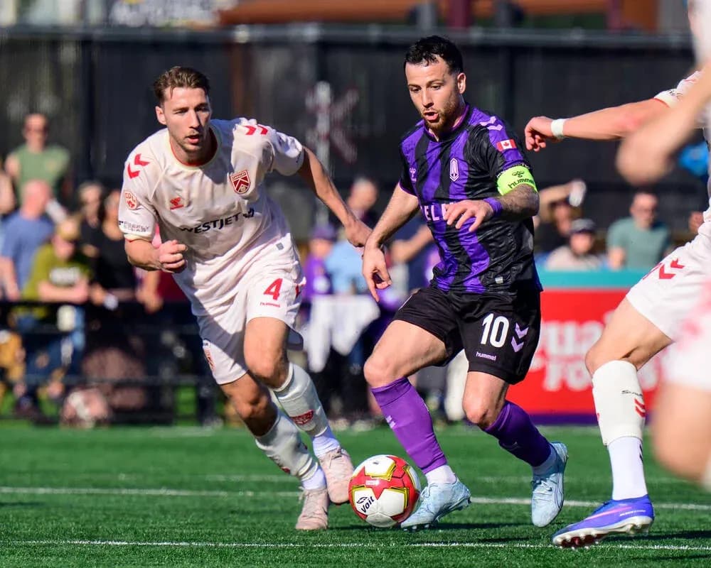 Cavalry FC player chasing the ball against Pacific FC