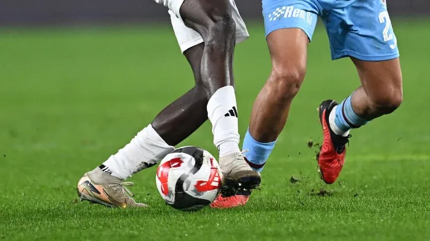 Two players challenging for the ball on field