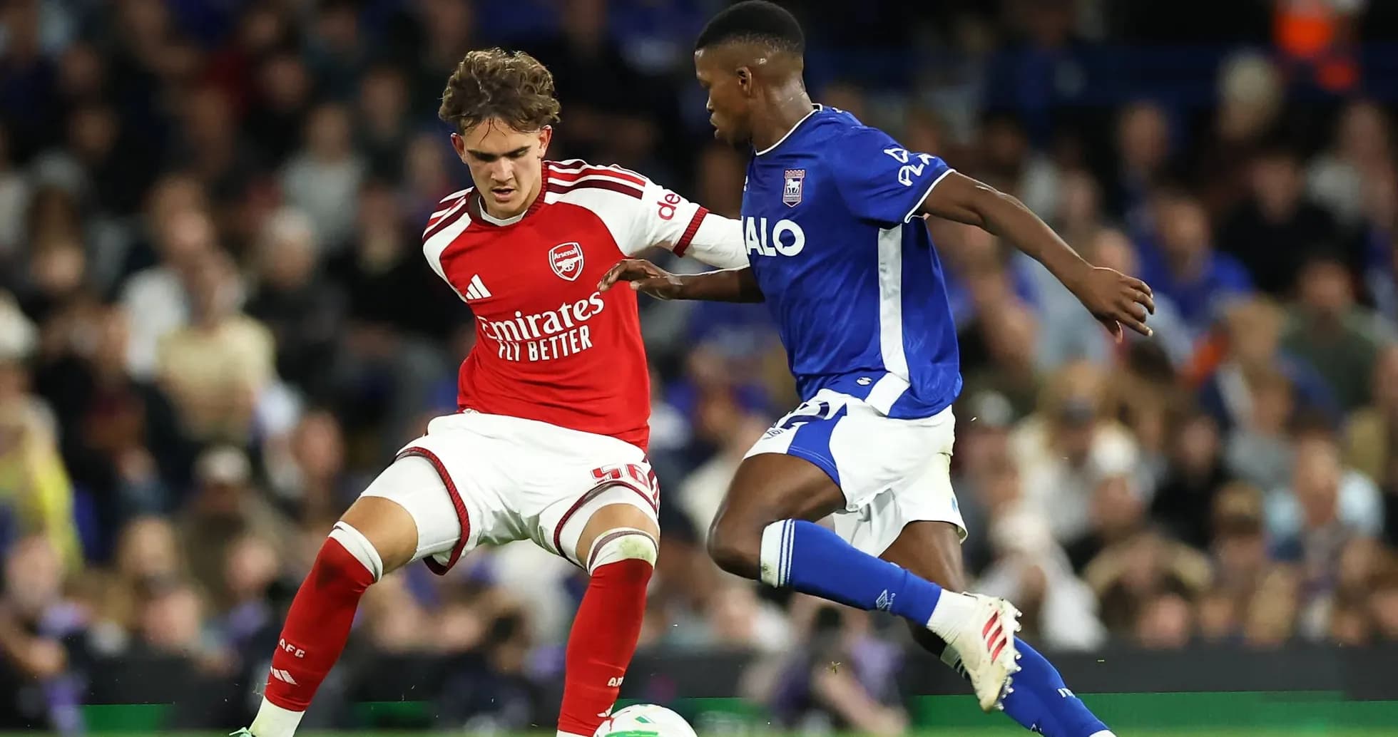 Arsenal player challenged by Ipswich Town opponent