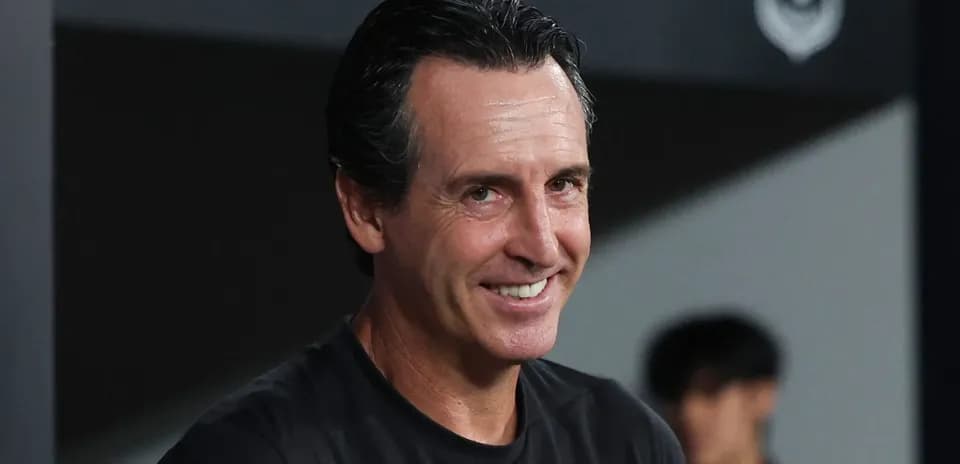 Football manager smiling on the sidelines