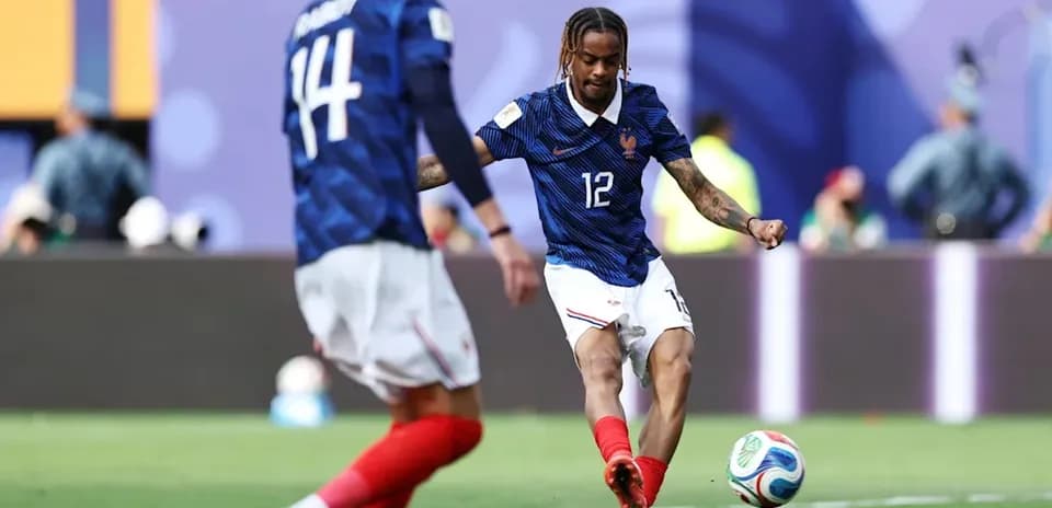 French player kicking soccer ball during match