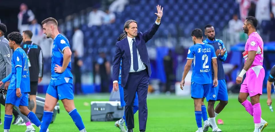 Coach waving to players after match in stadium