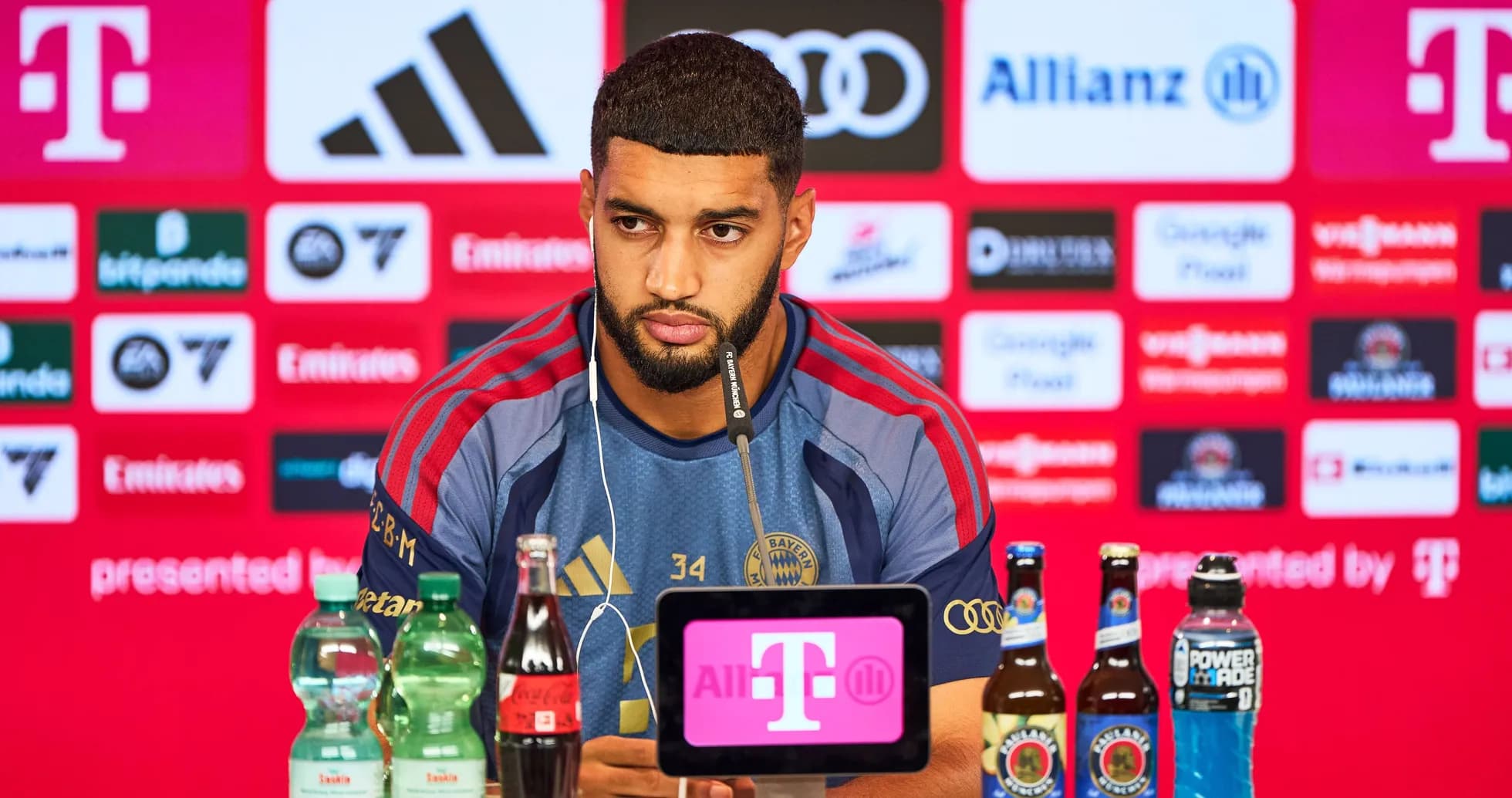 Player at press conference with sponsorship backdrop