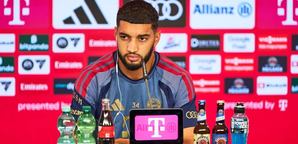 Player at press conference with sponsorship backdrop