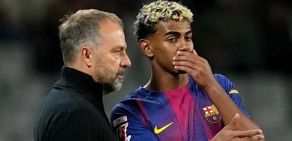 Coach discussing strategy with Barcelona player during match