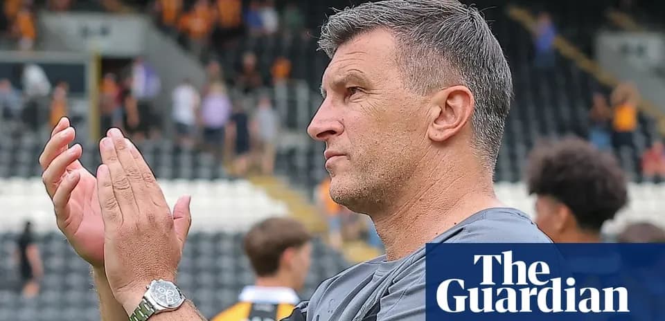 Coach applauding fans in stadium stands