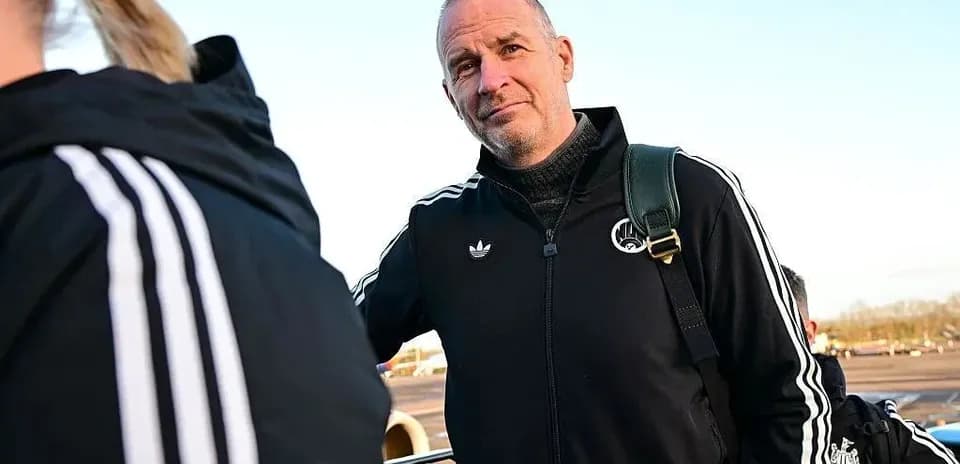 Coach standing near team at the airport