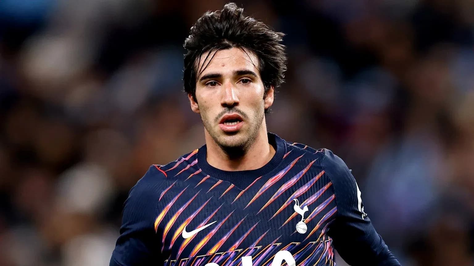 Player wearing Tottenham kit during match action
