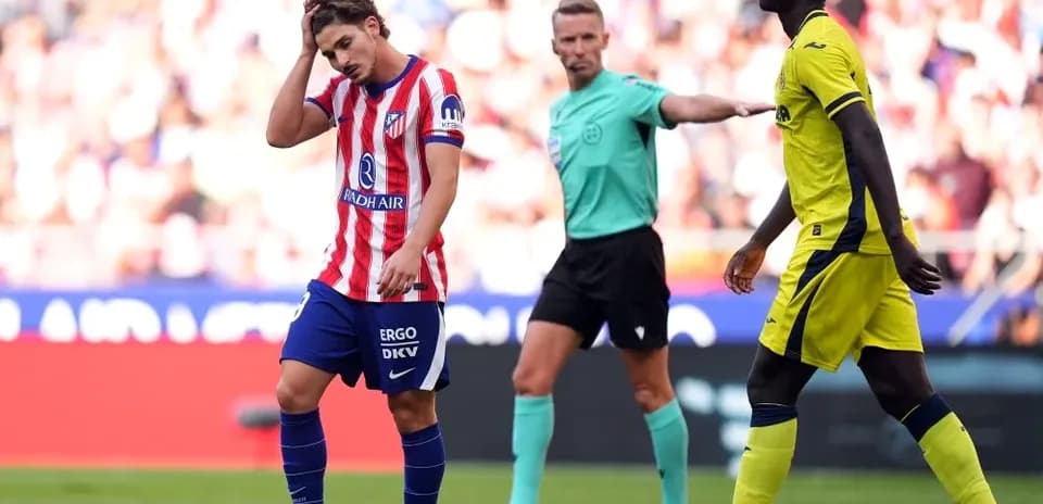 Atletico Madrid player reacts after a foul call