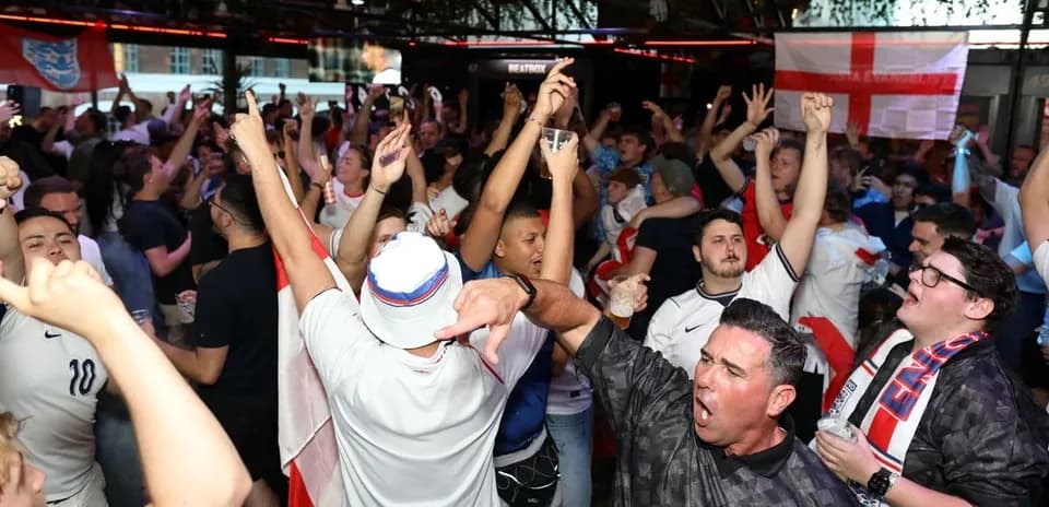 Crowd of fans celebrating in a lively venue