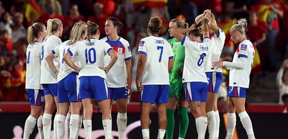 England women's team huddled during match preparation