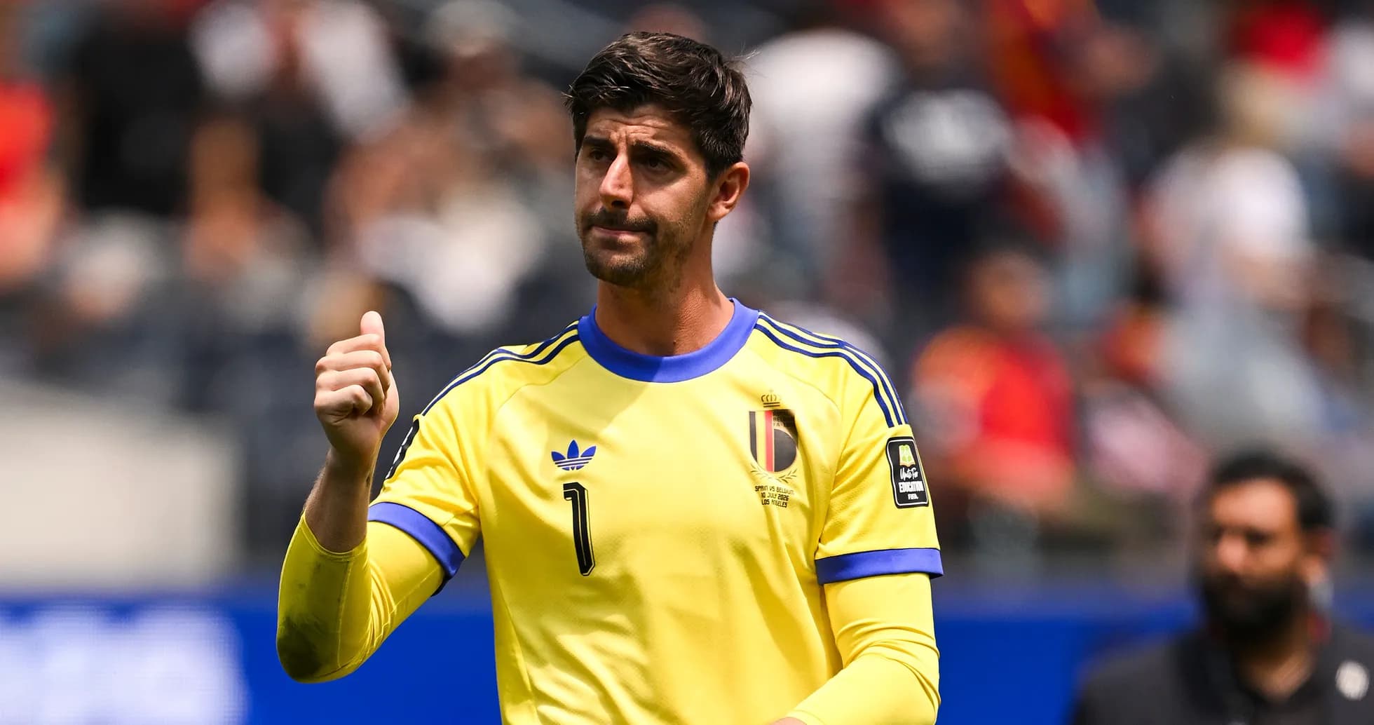 Goalkeeper in yellow jersey gesturing during match