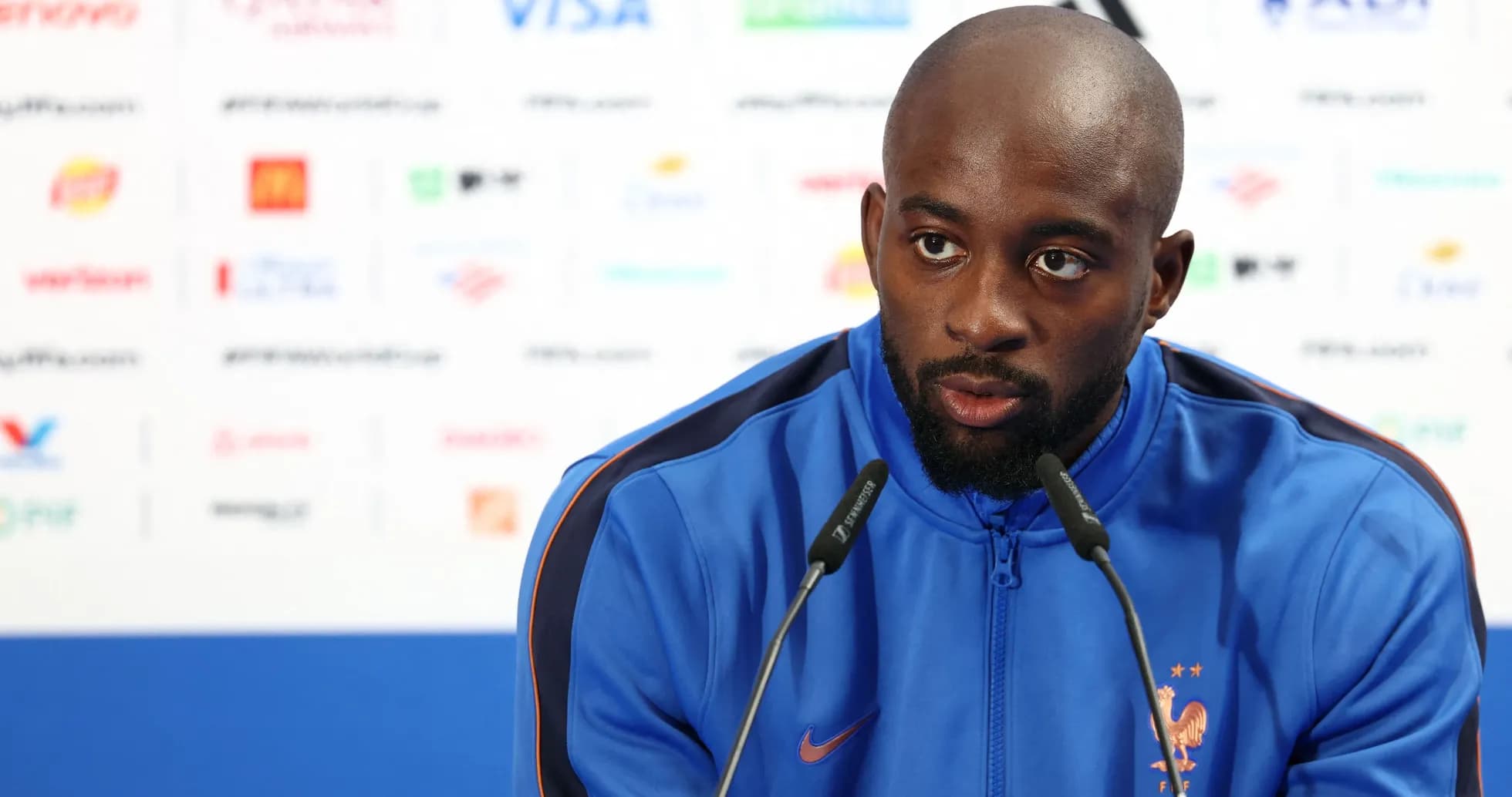 Player speaking at press conference with microphone