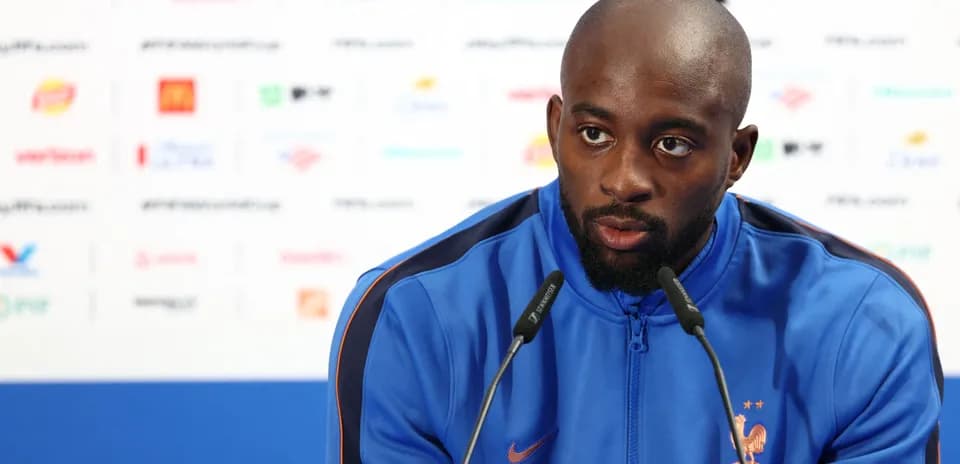Player speaking at press conference with microphone