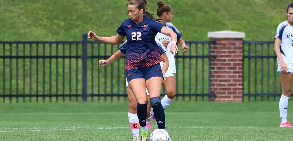 Player dribbling ball during soccer match