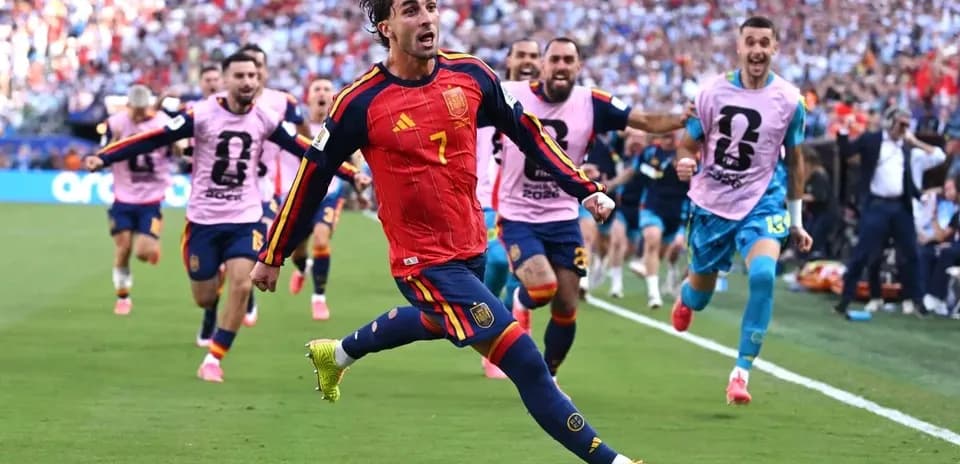 Spanish player celebrating a goal with teammates