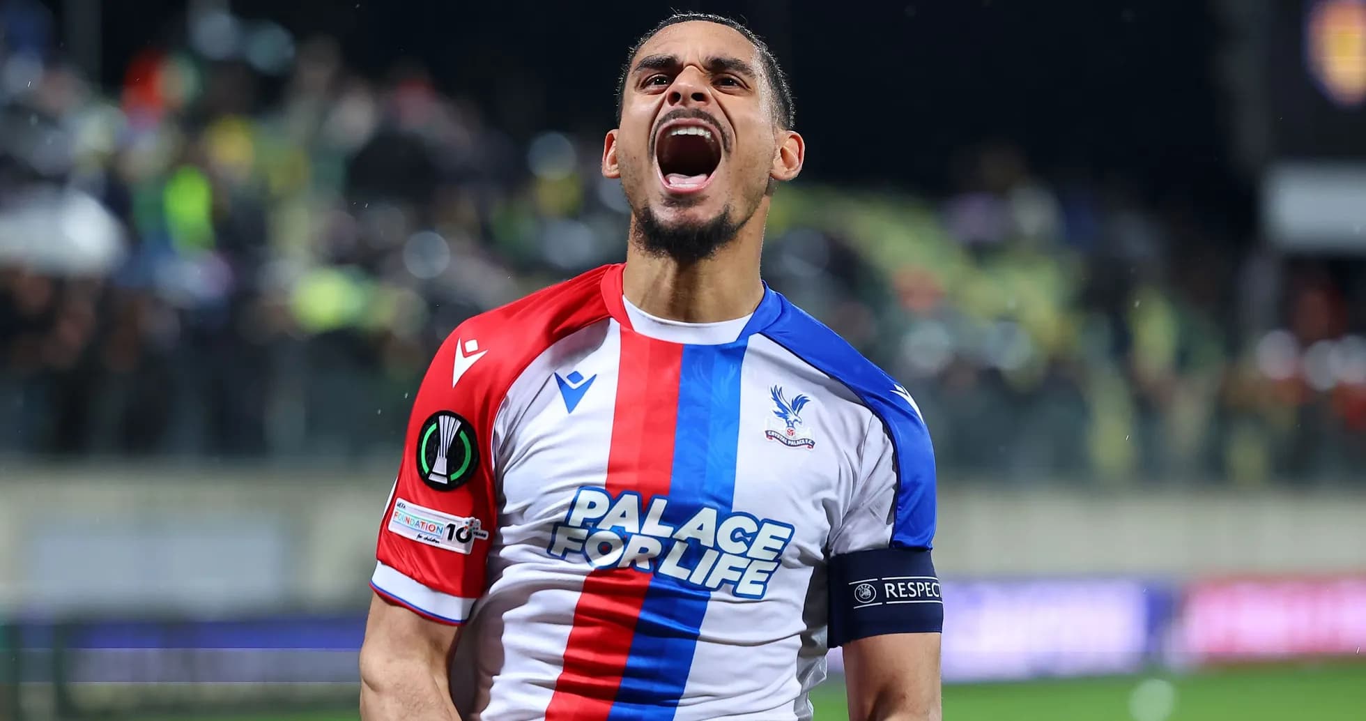 Player celebrating with arms raised on the field