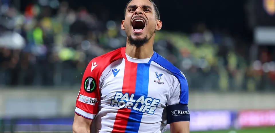Player celebrating with arms raised on the field