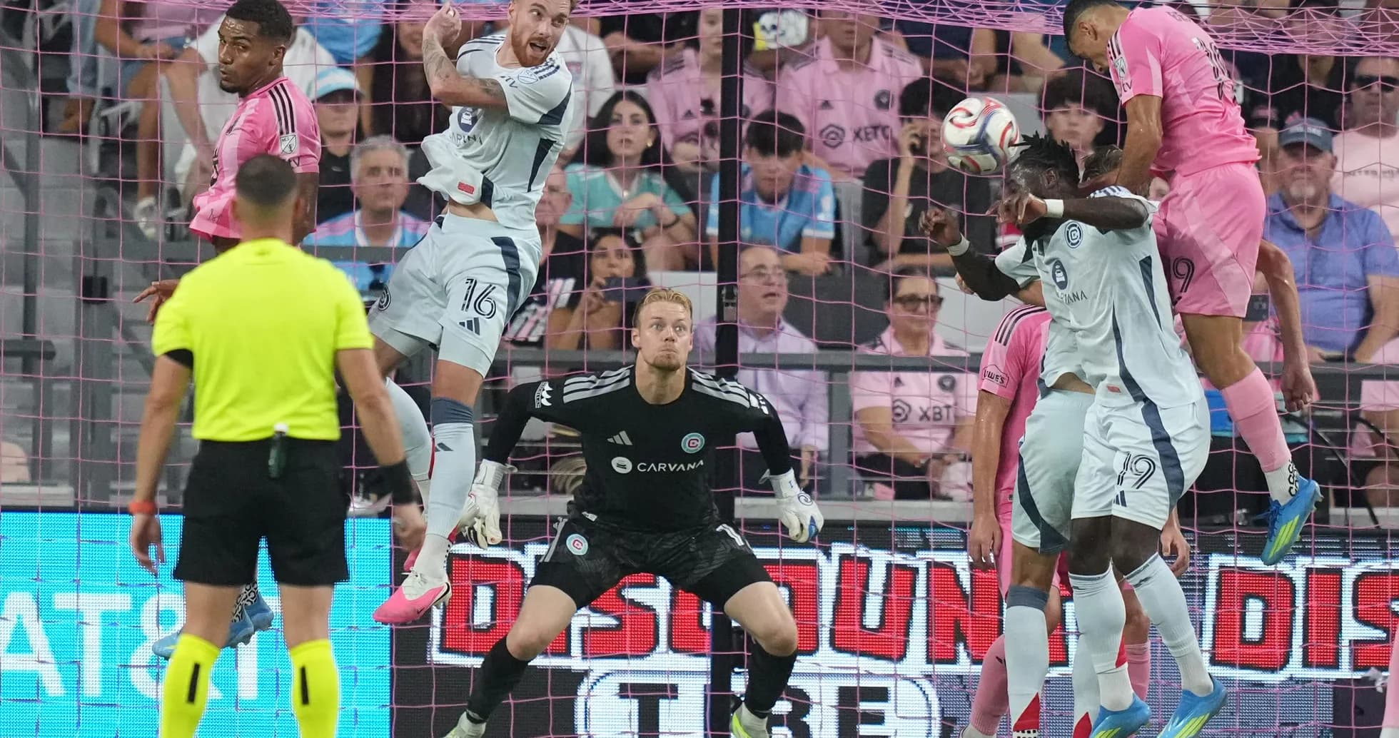 Players contesting a header during match action