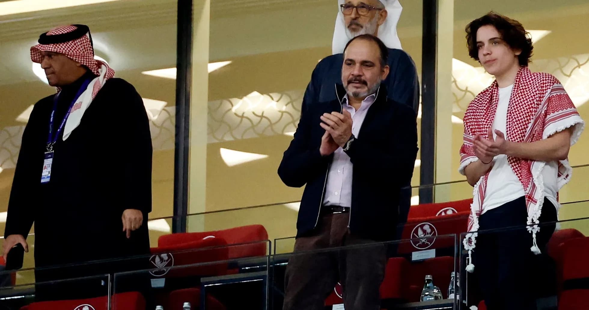 Group of spectators in stadium box applauding