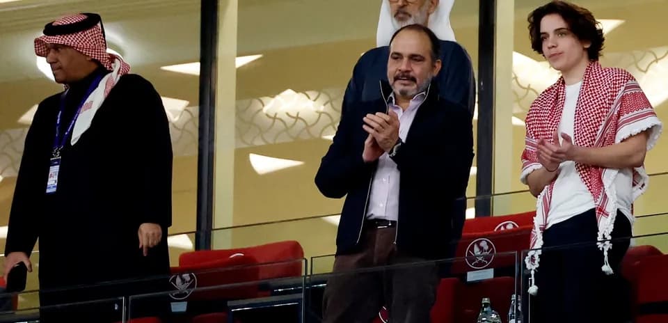 Group of spectators in stadium box applauding