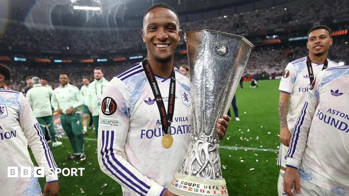 Player celebrating with UEFA trophy after victory