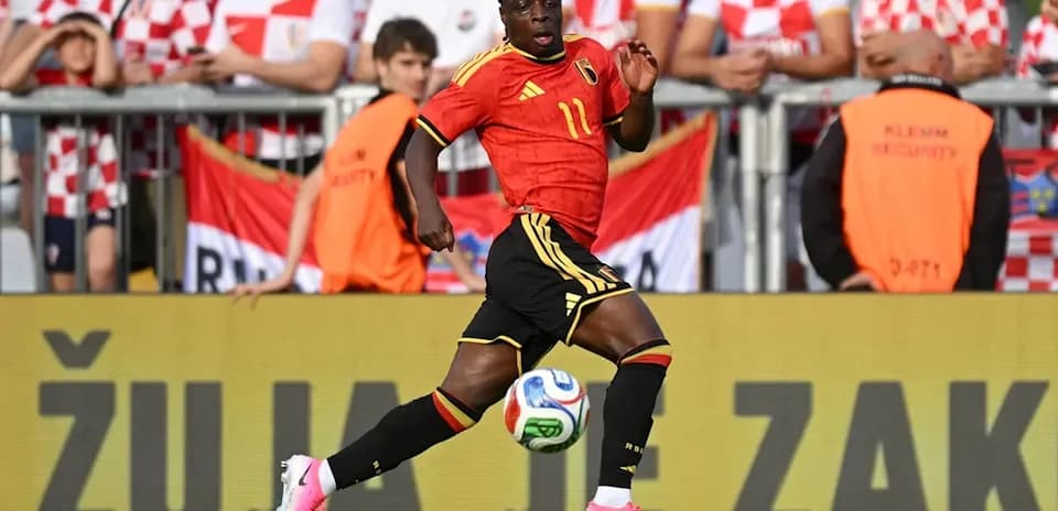 Belgian player sprinting on the field during match
