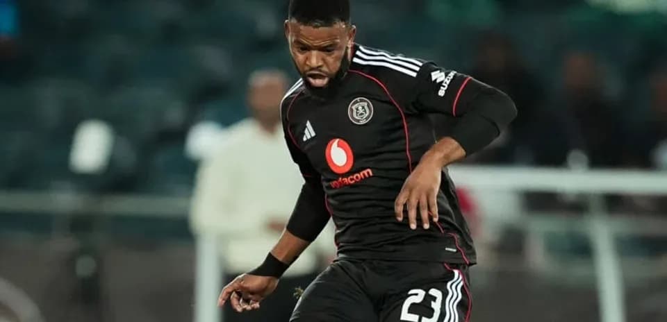 Player in black kit controlling the ball during match