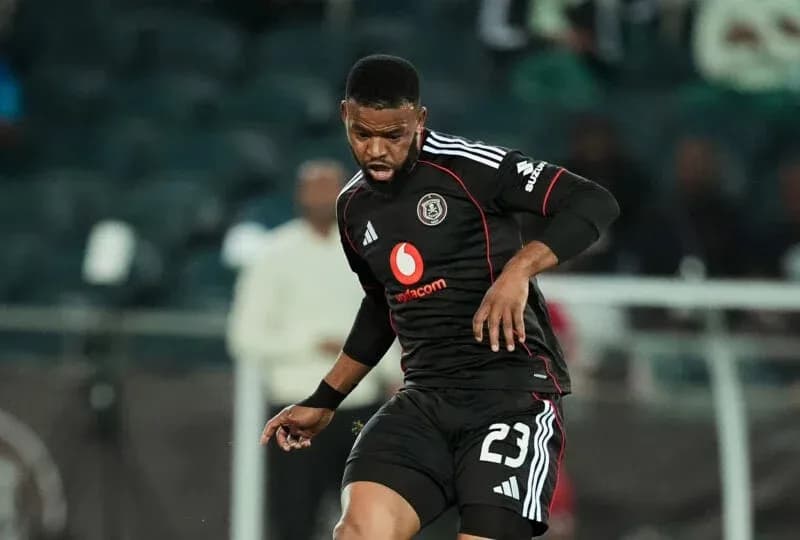 Player in black kit controlling the ball during match
